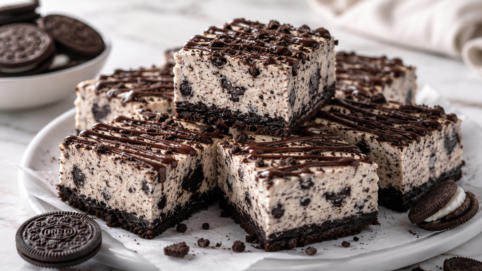 Creamy no bake Oreo cheesecake bars with a chocolate cookie crust and crushed Oreo topping.